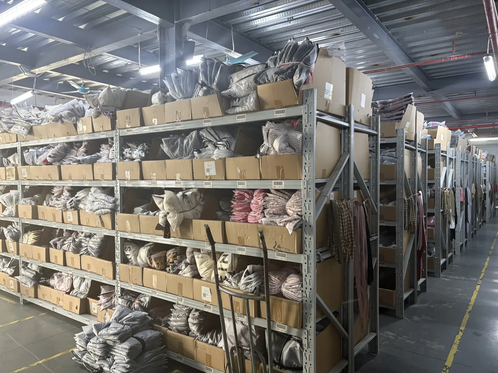 Clothing factory warehouse with packaged inventory ready for bulk apparel shipment