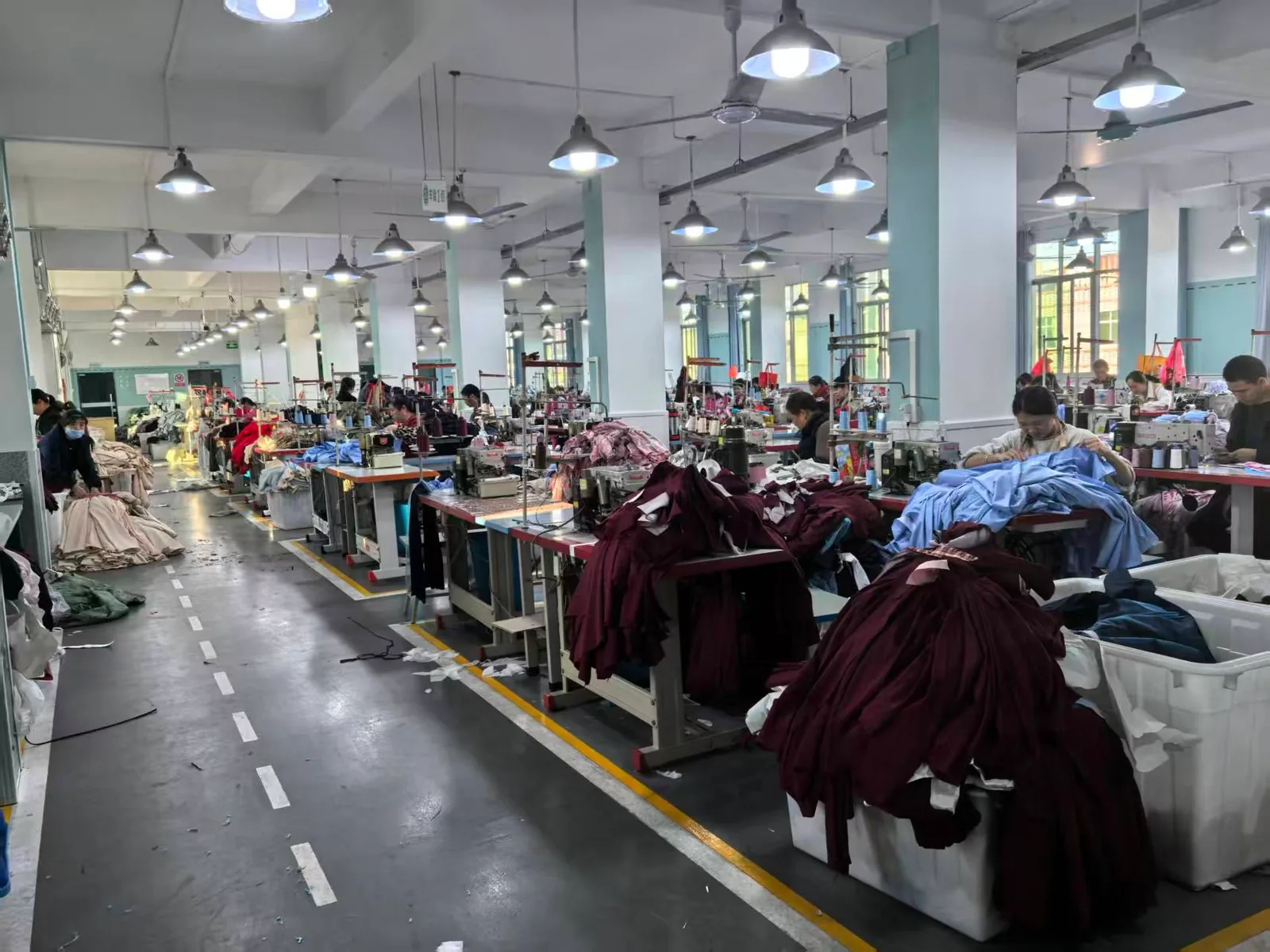 Sewing production line with red and blue fabric prepared for apparel manufacturing